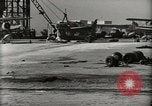 Image of Wrecked Planes Hangars and Ships Pearl Harbor Hawaii USA, 1942, second 16 stock footage video 65675033414
