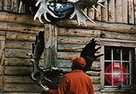 Image of Moose antlers being fastened to a log cabin Alaska USA, 1954, second 9 stock footage video 65675034930