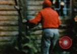 Image of Moose antlers being fastened to a log cabin Alaska USA, 1954, second 32 stock footage video 65675034930