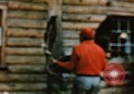 Image of Moose antlers being fastened to a log cabin Alaska USA, 1954, second 33 stock footage video 65675034930