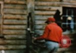 Image of Moose antlers being fastened to a log cabin Alaska USA, 1954, second 34 stock footage video 65675034930