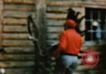 Image of Moose antlers being fastened to a log cabin Alaska USA, 1954, second 35 stock footage video 65675034930