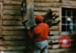 Image of Moose antlers being fastened to a log cabin Alaska USA, 1954, second 37 stock footage video 65675034930