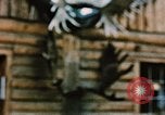 Image of Moose antlers being fastened to a log cabin Alaska USA, 1954, second 52 stock footage video 65675034930