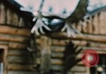 Image of Moose antlers being fastened to a log cabin Alaska USA, 1954, second 54 stock footage video 65675034930