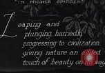 Image of waterfall and wild flowers United States USA, 1920, second 3 stock footage video 65675035759