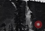 Image of waterfall and wild flowers United States USA, 1920, second 38 stock footage video 65675035759