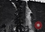 Image of waterfall and wild flowers United States USA, 1920, second 40 stock footage video 65675035759