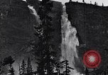 Image of waterfall and wild flowers United States USA, 1920, second 43 stock footage video 65675035759