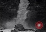 Image of waterfall and wild flowers United States USA, 1920, second 60 stock footage video 65675035759