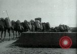 Image of native man leads camel herd Iran, 1908, second 8 stock footage video 65675036728