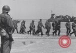 Image of U.S. troops hold German POWs on Normandy beach in World War II Normandy France, 1944, second 4 stock footage video 65675037057