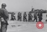 Image of U.S. troops hold German POWs on Normandy beach in World War II Normandy France, 1944, second 5 stock footage video 65675037057