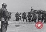 Image of U.S. troops hold German POWs on Normandy beach in World War II Normandy France, 1944, second 6 stock footage video 65675037057