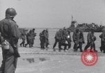 Image of U.S. troops hold German POWs on Normandy beach in World War II Normandy France, 1944, second 8 stock footage video 65675037057
