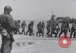 Image of U.S. troops hold German POWs on Normandy beach in World War II Normandy France, 1944, second 9 stock footage video 65675037057