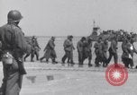 Image of U.S. troops hold German POWs on Normandy beach in World War II Normandy France, 1944, second 11 stock footage video 65675037057