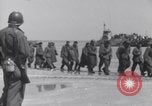 Image of U.S. troops hold German POWs on Normandy beach in World War II Normandy France, 1944, second 13 stock footage video 65675037057