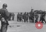Image of U.S. troops hold German POWs on Normandy beach in World War II Normandy France, 1944, second 14 stock footage video 65675037057