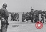 Image of U.S. troops hold German POWs on Normandy beach in World War II Normandy France, 1944, second 15 stock footage video 65675037057