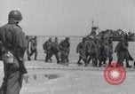 Image of U.S. troops hold German POWs on Normandy beach in World War II Normandy France, 1944, second 16 stock footage video 65675037057