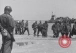 Image of U.S. troops hold German POWs on Normandy beach in World War II Normandy France, 1944, second 17 stock footage video 65675037057