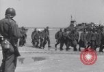 Image of U.S. troops hold German POWs on Normandy beach in World War II Normandy France, 1944, second 18 stock footage video 65675037057