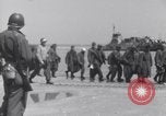 Image of U.S. troops hold German POWs on Normandy beach in World War II Normandy France, 1944, second 19 stock footage video 65675037057