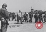 Image of U.S. troops hold German POWs on Normandy beach in World War II Normandy France, 1944, second 20 stock footage video 65675037057