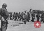 Image of U.S. troops hold German POWs on Normandy beach in World War II Normandy France, 1944, second 21 stock footage video 65675037057