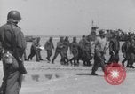 Image of U.S. troops hold German POWs on Normandy beach in World War II Normandy France, 1944, second 22 stock footage video 65675037057