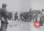 Image of U.S. troops hold German POWs on Normandy beach in World War II Normandy France, 1944, second 23 stock footage video 65675037057