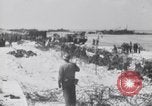 Image of U.S. troops hold German POWs on Normandy beach in World War II Normandy France, 1944, second 26 stock footage video 65675037057