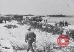 Image of U.S. troops hold German POWs on Normandy beach in World War II Normandy France, 1944, second 27 stock footage video 65675037057