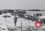 Image of U.S. troops hold German POWs on Normandy beach in World War II Normandy France, 1944, second 33 stock footage video 65675037057
