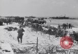 Image of U.S. troops hold German POWs on Normandy beach in World War II Normandy France, 1944, second 35 stock footage video 65675037057