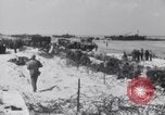 Image of U.S. troops hold German POWs on Normandy beach in World War II Normandy France, 1944, second 36 stock footage video 65675037057