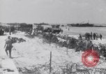 Image of U.S. troops hold German POWs on Normandy beach in World War II Normandy France, 1944, second 38 stock footage video 65675037057