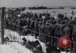 Image of U.S. troops hold German POWs on Normandy beach in World War II Normandy France, 1944, second 52 stock footage video 65675037057