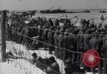 Image of U.S. troops hold German POWs on Normandy beach in World War II Normandy France, 1944, second 53 stock footage video 65675037057