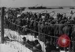 Image of U.S. troops hold German POWs on Normandy beach in World War II Normandy France, 1944, second 54 stock footage video 65675037057