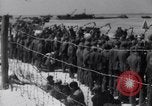 Image of U.S. troops hold German POWs on Normandy beach in World War II Normandy France, 1944, second 55 stock footage video 65675037057
