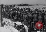 Image of U.S. troops hold German POWs on Normandy beach in World War II Normandy France, 1944, second 57 stock footage video 65675037057