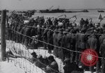 Image of U.S. troops hold German POWs on Normandy beach in World War II Normandy France, 1944, second 59 stock footage video 65675037057