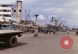 Image of Unloading of oil barrels Saigon Vietnam, 1966, second 8 stock footage video 65675037335