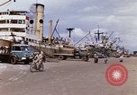 Image of Unloading of oil barrels Saigon Vietnam, 1966, second 9 stock footage video 65675037335