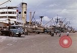 Image of Unloading of oil barrels Saigon Vietnam, 1966, second 10 stock footage video 65675037335