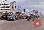 Image of Unloading of oil barrels Saigon Vietnam, 1966, second 11 stock footage video 65675037335