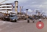Image of Unloading of oil barrels Saigon Vietnam, 1966, second 12 stock footage video 65675037335