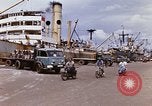 Image of Unloading of oil barrels Saigon Vietnam, 1966, second 13 stock footage video 65675037335